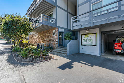 A car is parked in the garage of a modern apartment building.