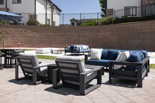 A set of outdoor furniture is arranged on a patio.