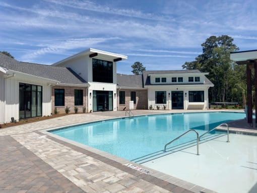 Large swimming pool in front of the exterior of building