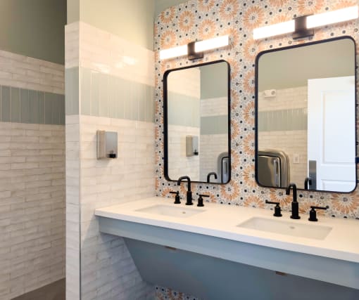 Clubhouse bathroom with two sinks and two mirrors