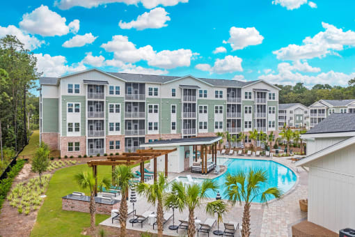 an aerial view of an apartment building with a swimming pool