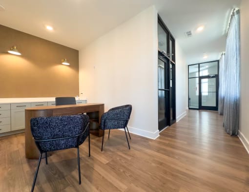 Leasing office with wooden table and chairs and windows