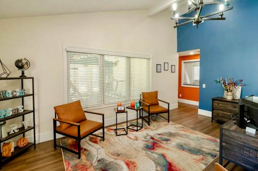 A leasing office with chairs and white and blue walls.