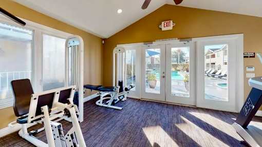A weight training gym with a weight bench and gym equipment.