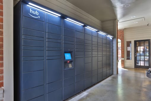 a row of blue lockers with the hub logo on the top at The Quarry Alamo Heights, San Antonio, TX
