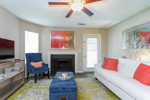 a living room with a couch and a chair and a fireplace