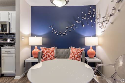a living room with a blue accent wall and a round table