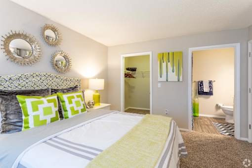 a bedroom with a large bed and a bathroom