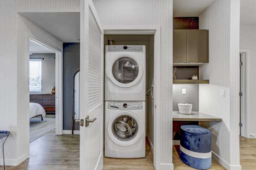 A washer and dryer are built into a wall in a small room.