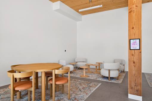 A room with a wooden table and chairs.