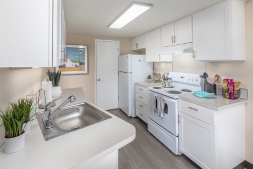 Kitchen with white appliances and white cabinets at Summerfield, Tigard