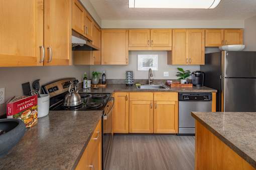 a kitchen with wooden cabinets and stainless steel appliances