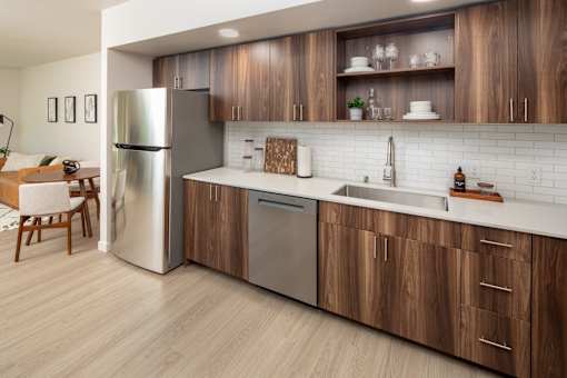 A modern kitchen with wooden cabinets and stainless steel appliances.