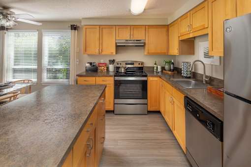 a kitchen with wooden cabinets and stainless steel appliances