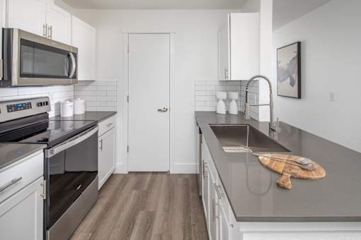 A kitchen with a stove top oven and a microwave.