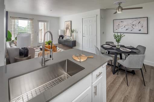 A modern kitchen with a dining table and chairs.