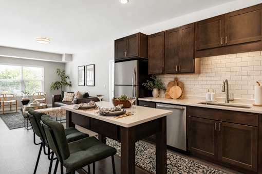 A modern kitchen with dark brown cabinets and a white countertop.