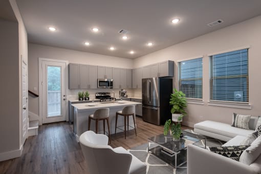 a living room with a kitchen and a couch and a table