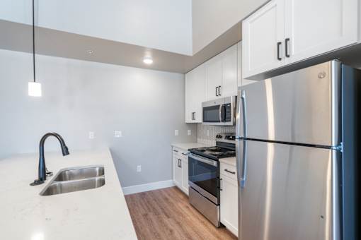 a kitchen with stainless steel appliances and white cabinets