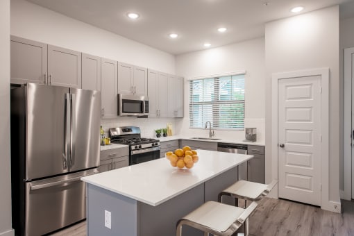 a kitchen with stainless steel appliances and a white counter top