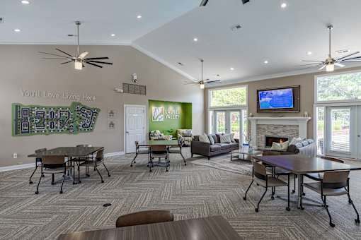 A living room with a fireplace and a TV on the wall.