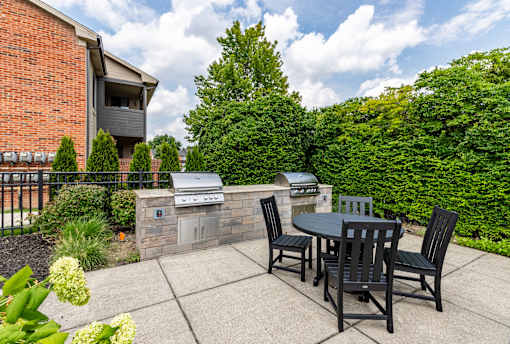 A patio with a table and chairs is set up outside a house.