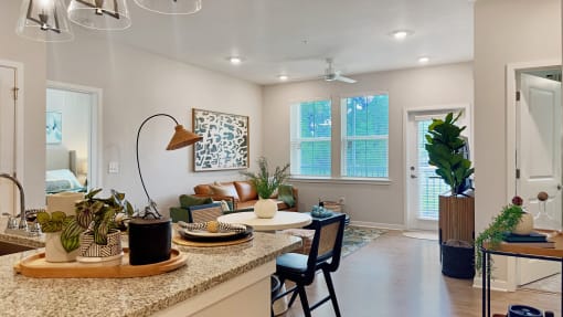 an open kitchen and living room with a table and chairs