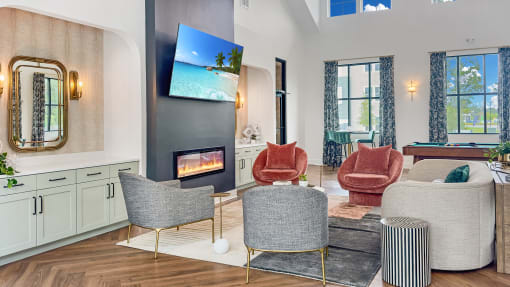 a living room with chairs and a fireplace