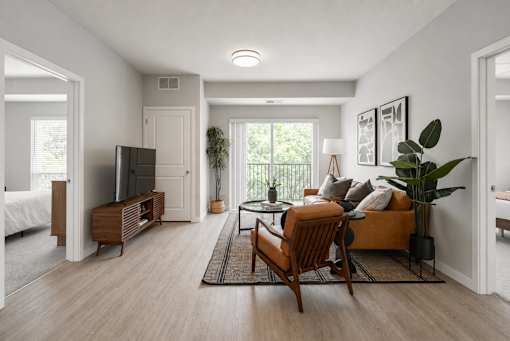 A living room with a sofa, a chair, and a television.