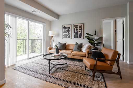 A living room with a brown leather chair and a black coffee table.