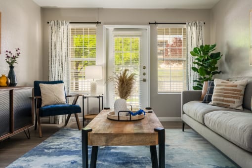 Living Room With Glass Windows at Odyssey Apartments, Albuquerque