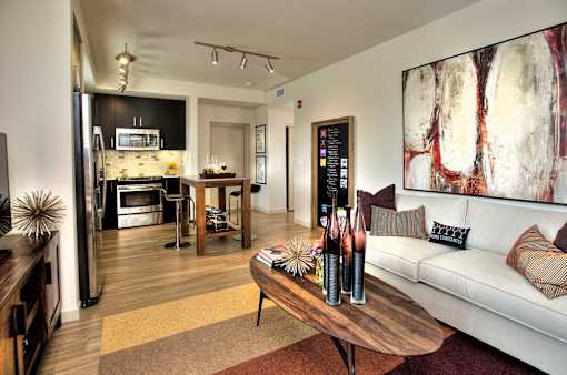 Furnished open-concept living space with view of the kitchen at Annadel Downtown Santa Rosa apartments.