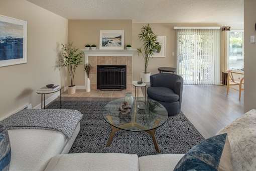 a living room with a couch and a chair and a fireplace
