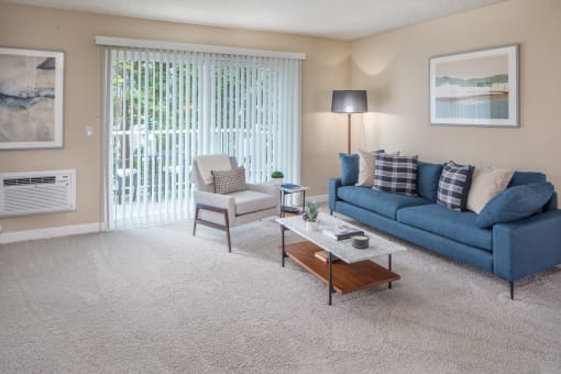 Living room with a blue couch and a coffee table at Summerfield, Tigard