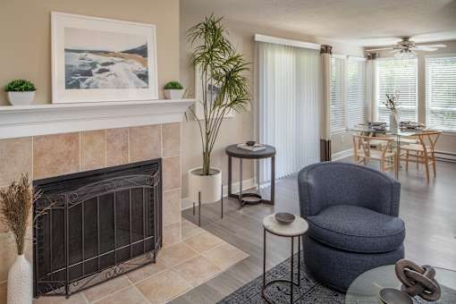 a living room with a fireplace and a table with chairs