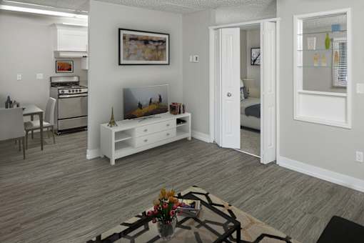 A living room with a white couch and a painting on the wall.