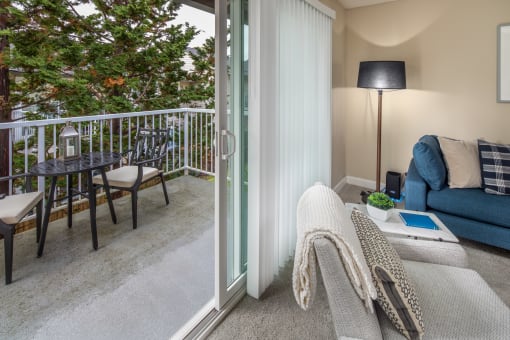 Living room with sliding glass doors to a balcony at Summerfield, Tigard, 97224