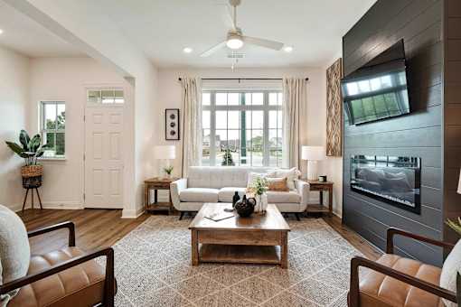 A modern living room with a brown rug and a white sofa.