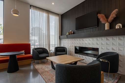 A modern living room with a fireplace and a television.