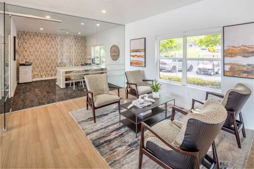 A living room with a glass table and chairs.