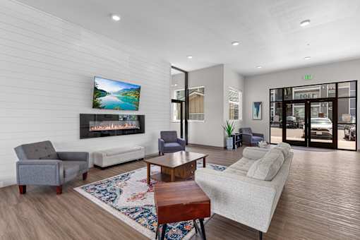 A living room with a flat screen TV mounted on the wall.