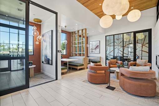 A modern living room with a glass door leading to a balcony.