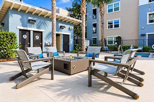 A poolside table and chairs are set up on a patio.