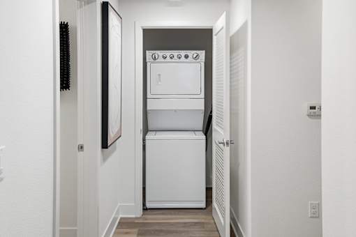 A white oven and dishwasher in a narrow hallway.