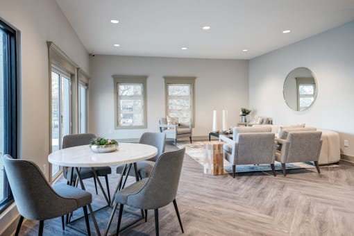 a dining room with a table and chairs and a living room