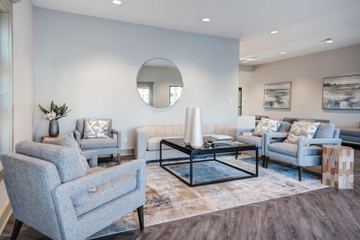 a living room with blue furniture and a mirror