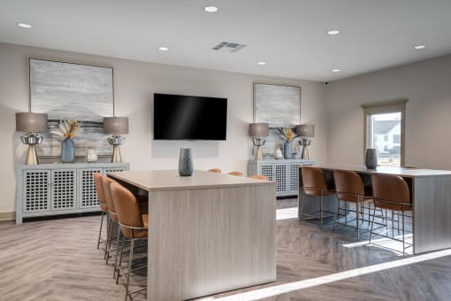 a conference room with a table and chairs and a tv