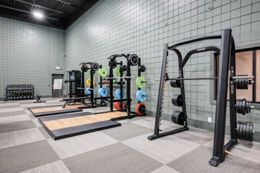 the weights room in the new fitness center at the house