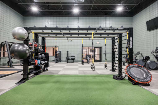 a workout room with weights and other equipment in a gym