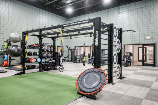 a tire in the center of a gym with weights and other equipment